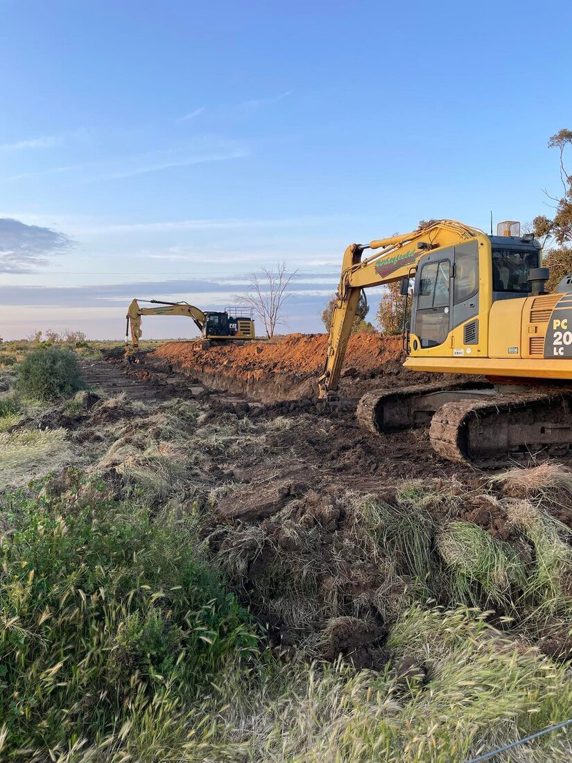 Excavator preparing a drainage line